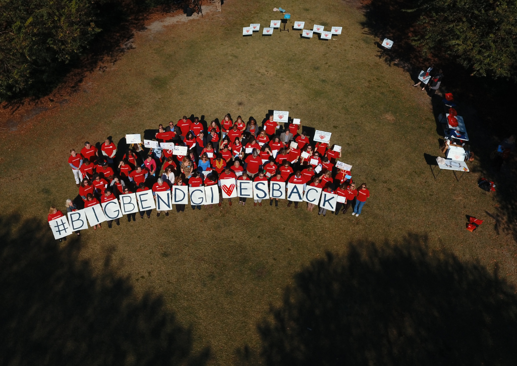 Drone photo from up high, dozens of Big Bend residents hold signs that spell out "Big Bend Gives Back"