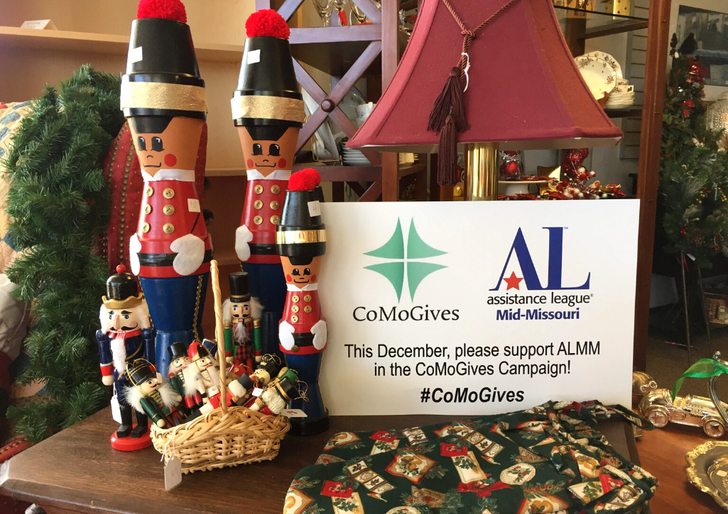 Nutcrackers on a table with sign next to them that says "support Como Gives"