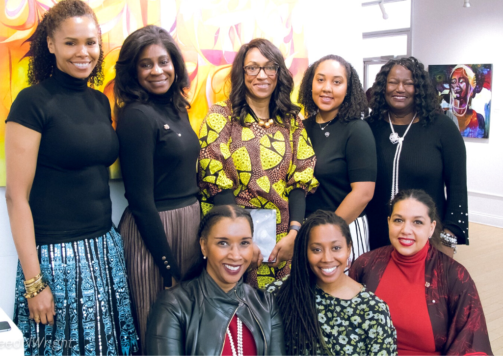 9 Black women posing together at their giving circle event