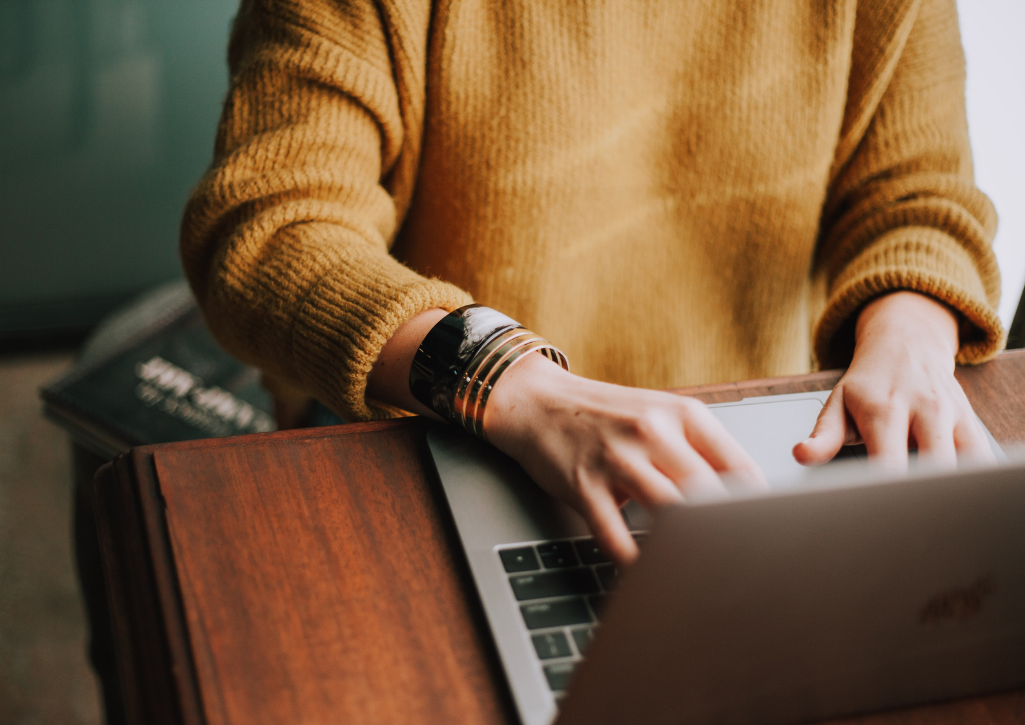 A woman typing on a laptop