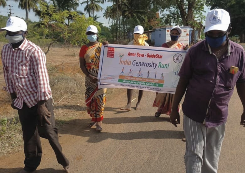 People in India holding a sign that says "India Generosity Run"