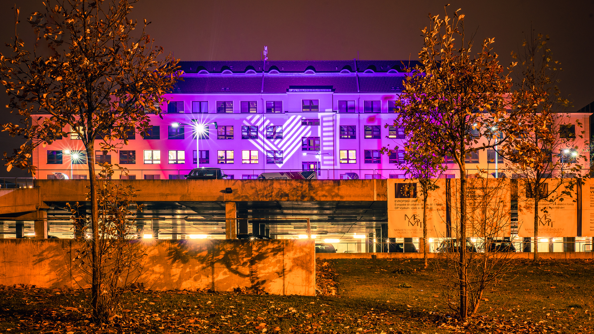 A hospital lit up in purple with the GivingTuesday heart