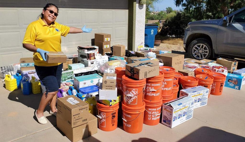 A member of Auntie's Sewing Squad showing off tons of supplies they collected to give to an indigenous reservation 