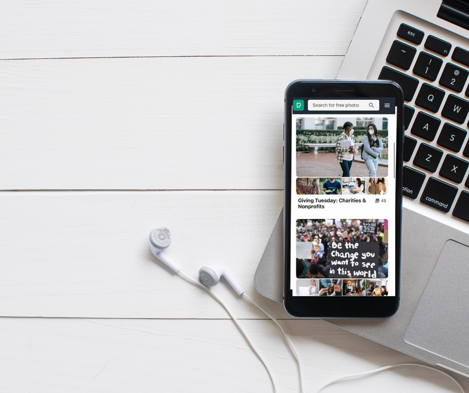 A mobile phone with the Pexels website open to the GivingTuesday profile. It has a number of small thumbnails of images showing social goood