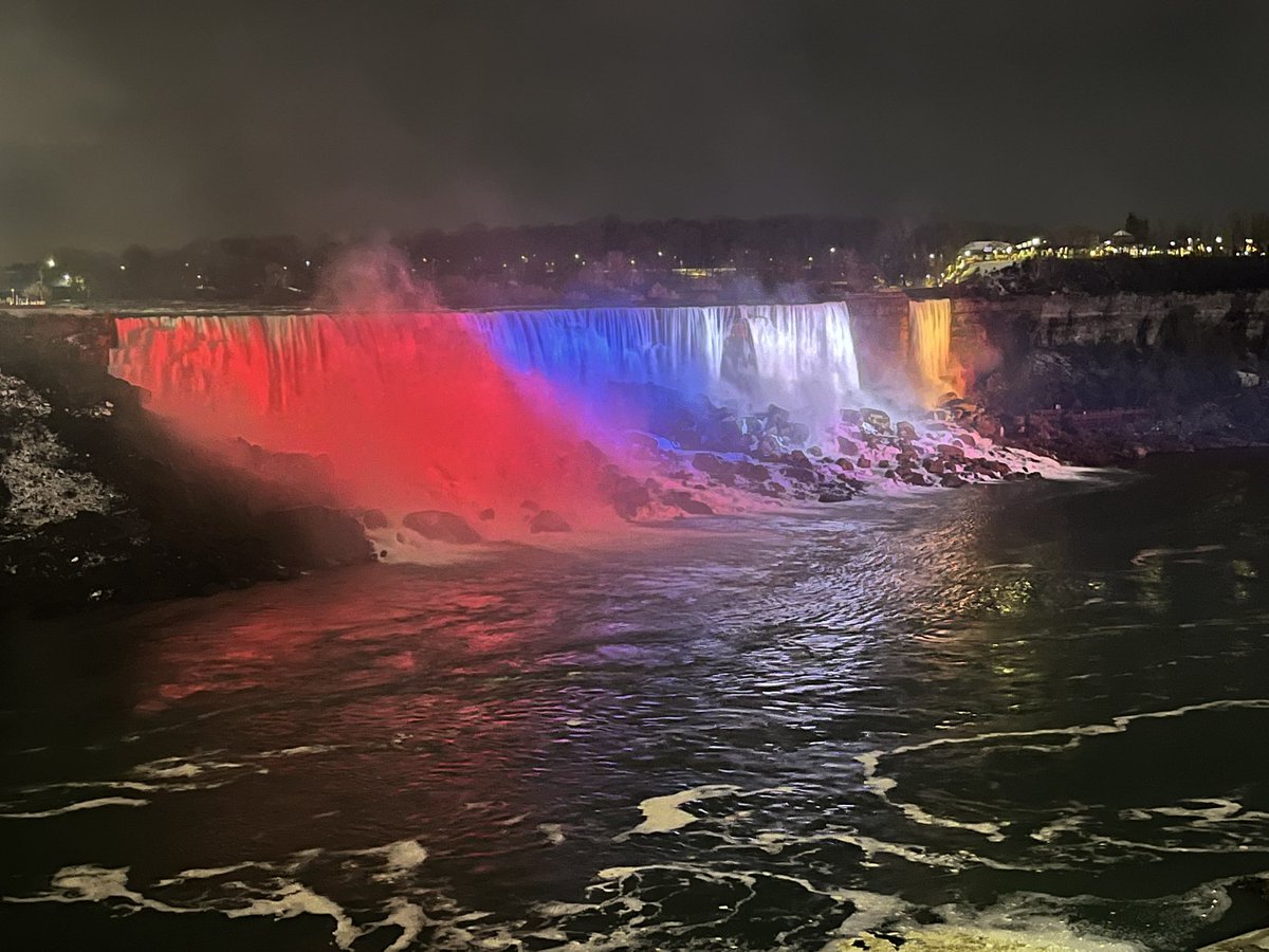 Niagara falls lit up at night in red white and blue
