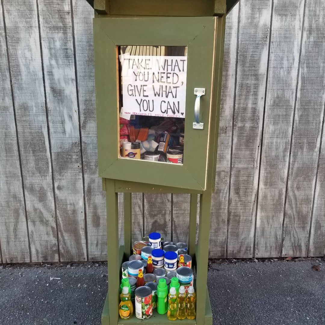 A little free food pantry. the sign says take what you need and give what you can