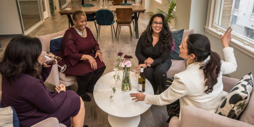 women sitting in a circle discussing who they're going to fund for their giving circle