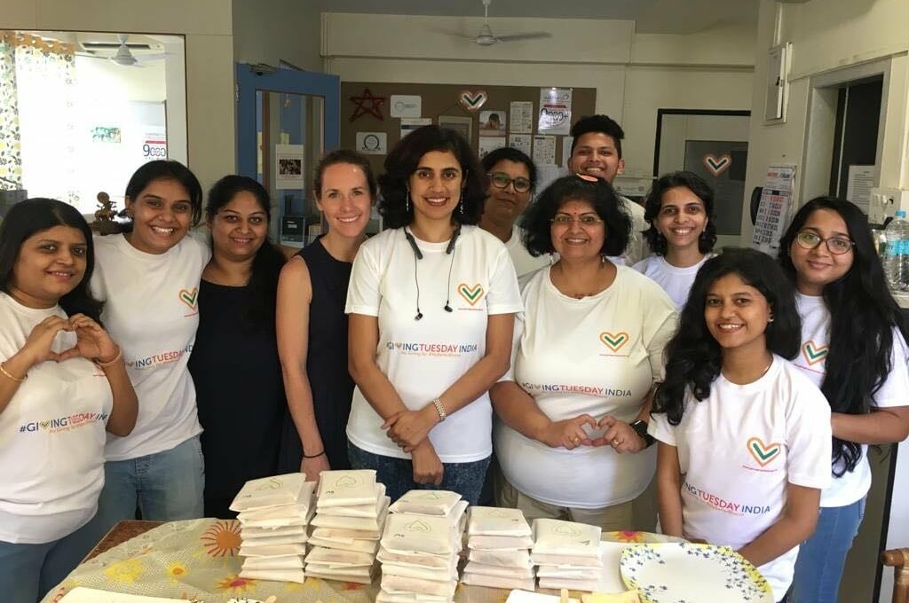 a group photo of people wearing GivingTuesday India tshirts