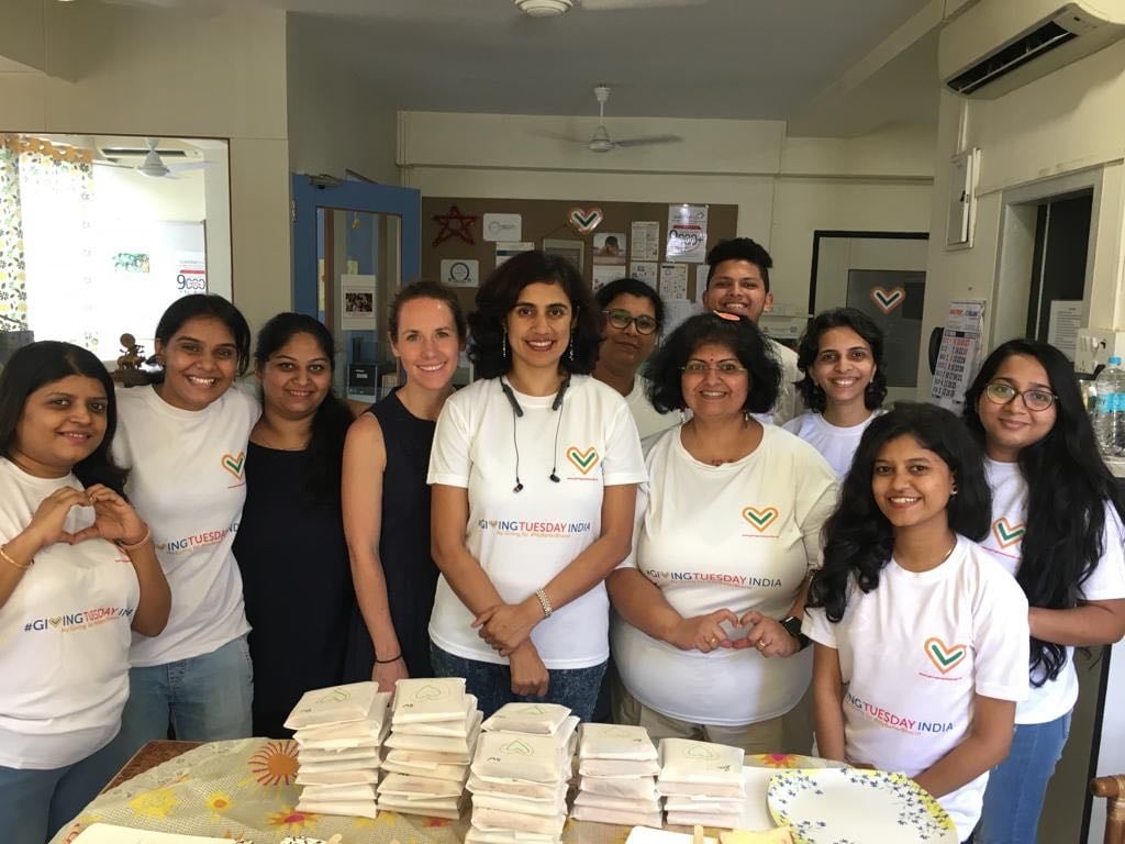 a group photo of people wearing GivingTuesday India tshirts
