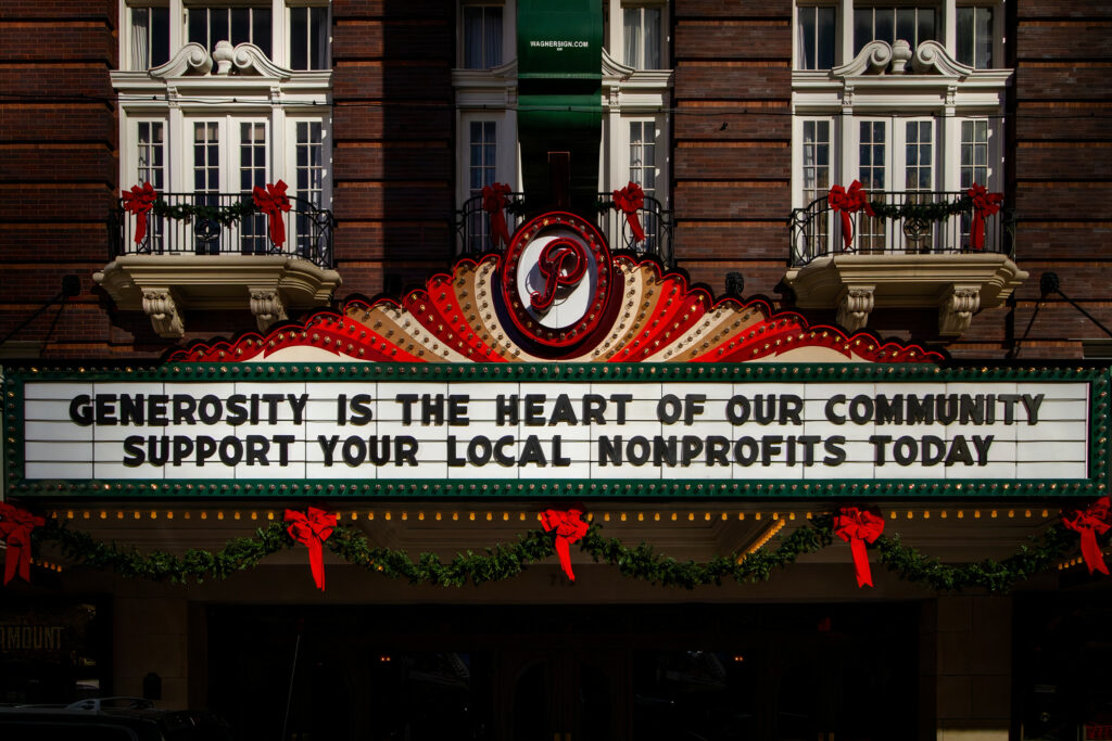 a marquee at a theater that says Generosity is the heart of our community. Suppor your local nonprofits