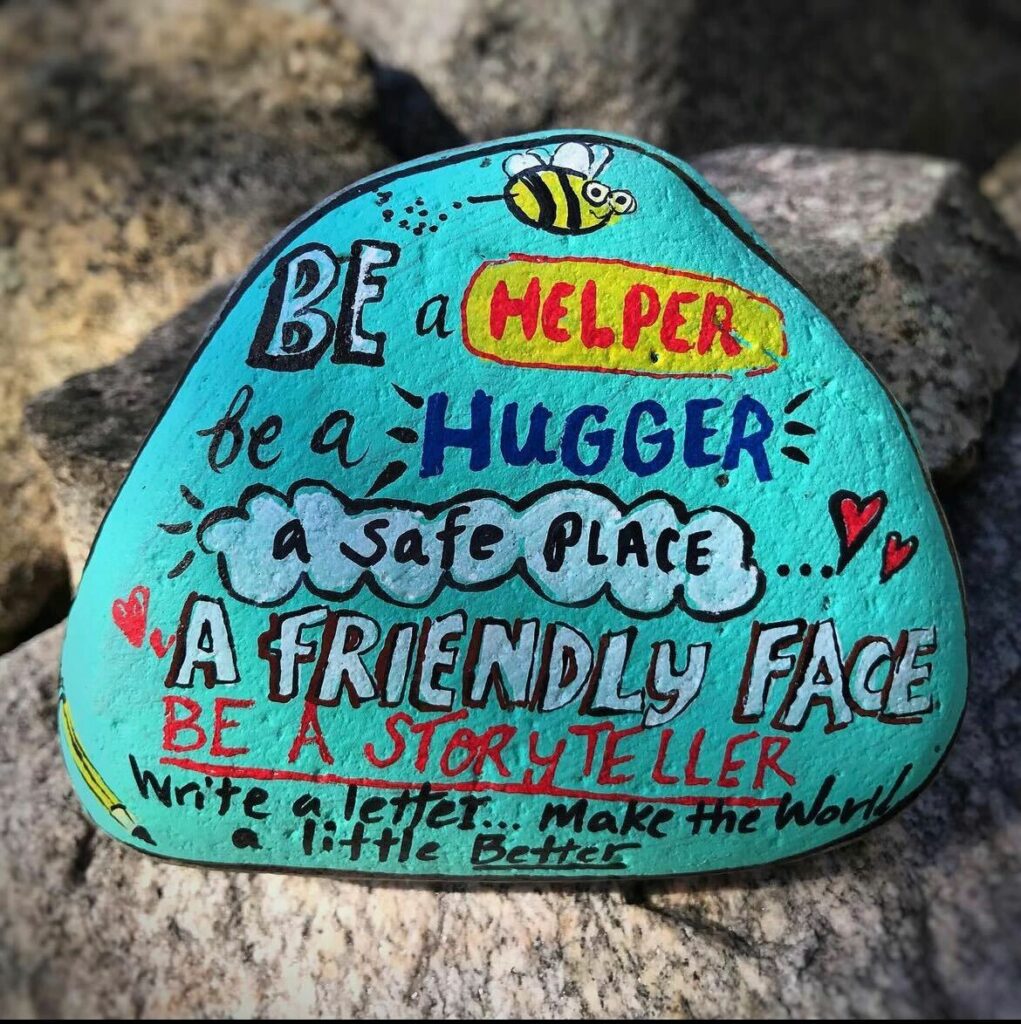kindness rock that says "be a hugger, be a helper, make the world a little better"