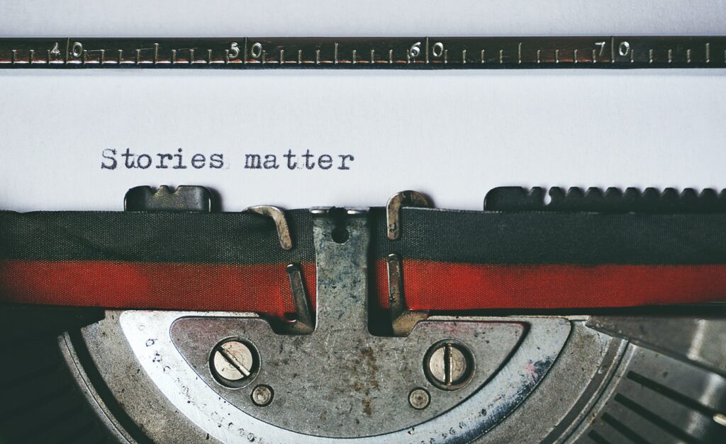 a typewriter that says "stories matter"