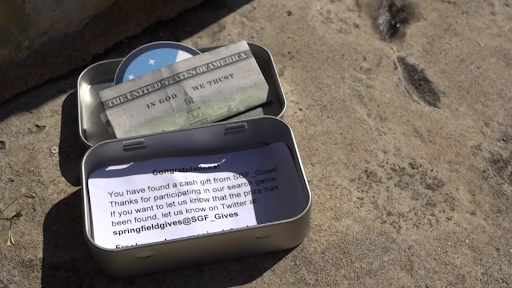 a tin with a message and cash in it