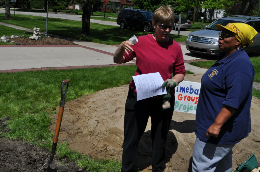 two women working on a timebanking landscape project