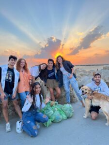 Tuesdays for Trash crew celebrating on the beach